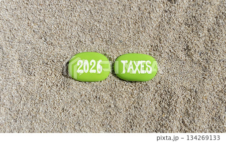 2026 taxes new year symbol. Concept words 2026 taxes on beautiful green stones on sand beach. Beautiful sand beach background. Business and 2026 taxes new year concept. Copy space. 2026 taxes new year symbol. Concept words 2026 taxes on beautiful green stones on sand beach. Beautiful sand beach background. Business and 2026 taxes new year concept. Copy space. 134269133