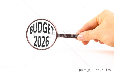 Budget 2026 symbol. Concept words Budget 2026 on beautiful white paper. Black magnifying glass. Businessman's hand. Beautiful white paper background. Business and budget 2026 concept. Copy space. Budget 2026 symbol. Concept words Budget 2026 on beautiful white paper. Black magnifying glass. Businessman's hand. Beautiful white paper background. Business and budget 2026 concept. Copy space. 134269179