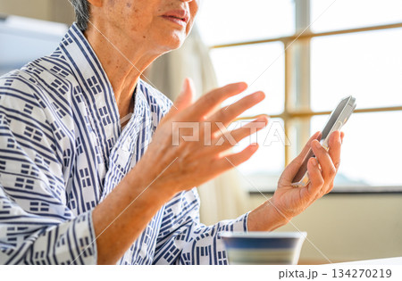 浴衣姿の高齢者がスマホで通話 134270219