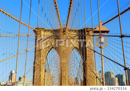 View from Brooklyn Bridge showing cables stone structure under clear blue sky 134270316
