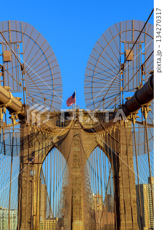 Brooklyn Bridge view with American flag in New York City 134270317