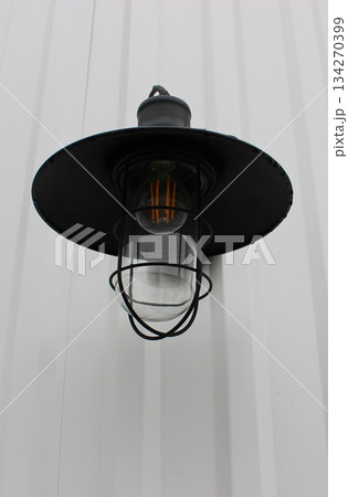 Outdoor Wall Lamp with Metal Cone Visor. Stylish Lighting for House Wall Bottom View Outdoor Wall Lamp with Metal Cone Visor. Stylish Lighting for House Wall Bottom View 134270399