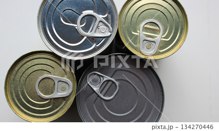 Top Lids of Four Different Metal Tin Cans Isolated on White Stock Photo. Pull Rings of Aluminum Cans with Preserved Food 134270446