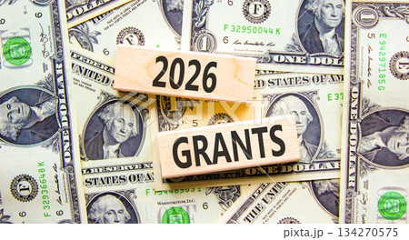 2026 Grants symbol. Concept words 2026 Grants on beautiful wooden blocks. Beautiful dollar bills background. Dollar bills. Business and 2026 grants concept. Copy space. 134270575