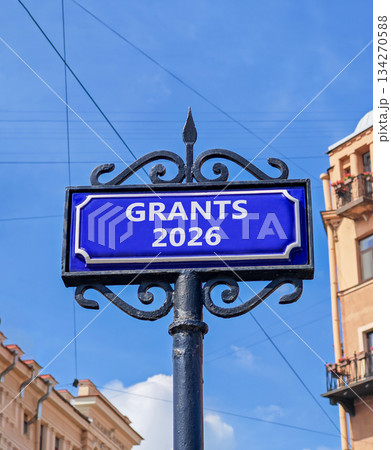 Grants 2026 symbol. Concept words Grants 2026 on beautiful blue road sign. Beautiful blue sky and buildings background. Business and grants 2026 concept. Copy space. 134270588