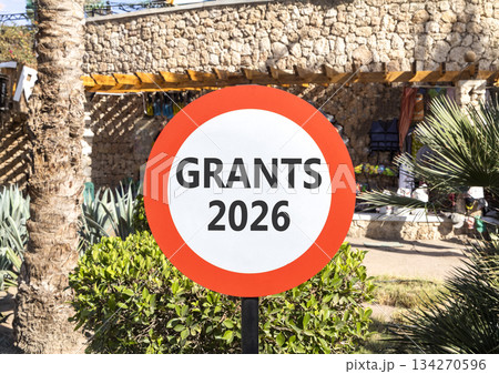 Grants 2026 symbol. Concept words Grants 2026 on beautiful white and red road sign. Beautiful palm trees palm-trees background. Business and grants 2026 concept. Copy space. 134270596