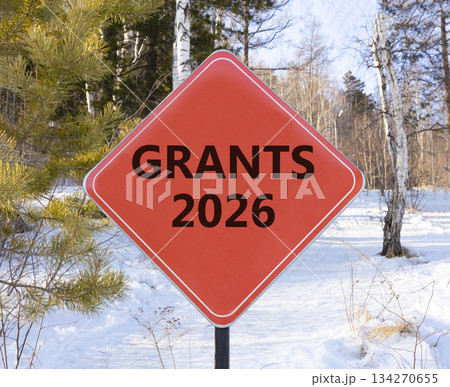 Grants 2026 symbol. Concept words Grants 2026 on beautiful red road sign. Beautiful winter forest background. Business and grants 2026 concept. Copy space. Grants 2026 symbol. Concept words Grants 2026 on beautiful red road sign. Beautiful winter forest background. Business and grants 2026 concept. Copy space. 134270655