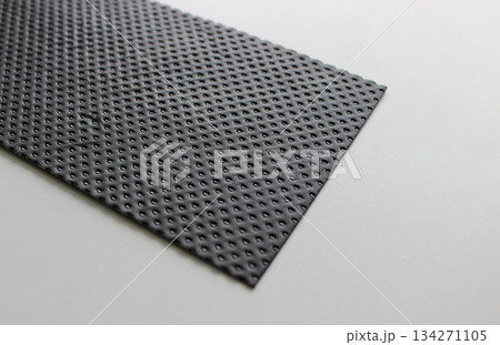 Perforated Structure Of Plastic Sheet On White Surface Angle View Perforated Structure Of Plastic Sheet On White Surface Angle View 134271105