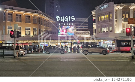 This is Bugis Street glows at night with neon signage, colonial facades, bustling traffic 134271190