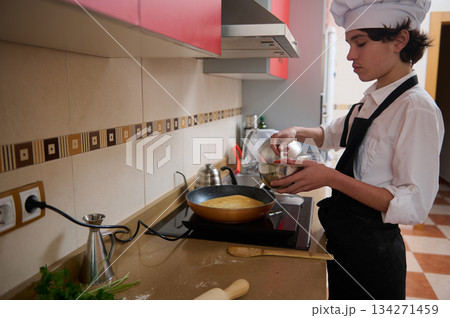 Chef Student Preparing Pancake Batter in Modern Kitchen for Class Recipe 134271459