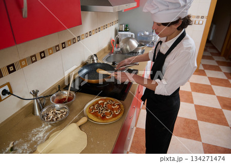Chef In White Hat Cooking Pizza In Modern Kitchen With Fresh Mushrooms Chef In White Hat Cooking Pizza In Modern Kitchen With Fresh Mushrooms 134271474
