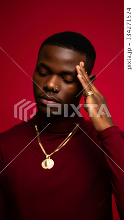 Stylish Young Man in a Maroon Turtleneck Shirt Poses Against a Vibrant Red Background 134271524