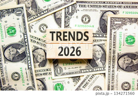 Trends 2026 new year symbol. Concept words Trends 2026 on beautiful wooden blocks. Beautiful dollar bills background. Dollar bills. Business and Trends 2026 new year concept. Copy space. Trends 2026 new year symbol. Concept words Trends 2026 on beautiful wooden blocks. Beautiful dollar bills background. Dollar bills. Business and Trends 2026 new year concept. Copy space. 134271560