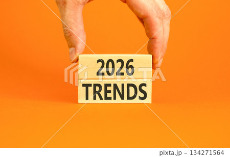 2026 Trends new year symbol. Concept words 2026 Trends on beautiful wooden blocks. Beautiful orange paper background. Businessman's hand. Business and 2026 Trends new year concept. Copy space. 134271564
