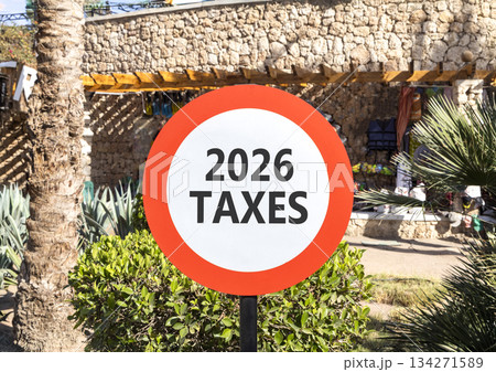 2026 taxes new year symbol. Concept words 2026 taxes on beautiful white and red road sign. Beautiful palm trees palm-trees background. Business and 2026 taxes new year concept. Copy space 2026 taxes new year symbol. Concept words 2026 taxes on beautiful white and red road sign. Beautiful palm trees palm-trees background. Business and 2026 taxes new year concept. Copy space 134271589