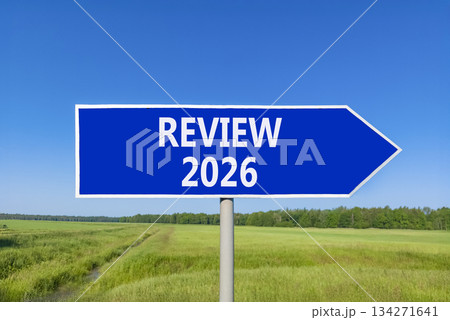 Review 2026 symbol. Concept words Review 2026 on beautiful blue road sign. Beautiful green grass field forest and blue sky background. Business and review 2026 concept. Copy space. 134271641