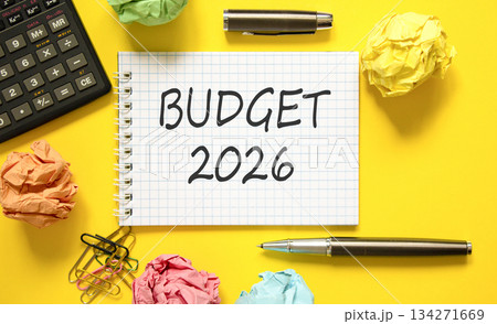 Budget 2026 symbol. Concept words Budget 2026 on beautiful white note. Beautiful yellow paper background. Beautiful black pen, calculator. Business and budget 2026 concept. Copy space. 134271669