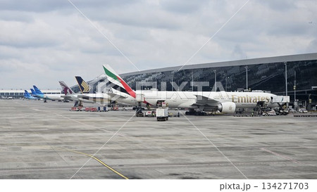 A lineup of global airlines including Emirates, Singapore Airlines, and Qatar Airways showcases international aviation activity 134271703