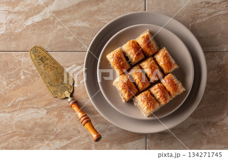 Baklava with walnuts on a beige plate. Baklava with walnuts on a beige plate. 134271745
