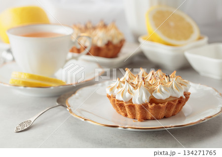 Meringue lemon tart on a white table. Meringue lemon tart on a white table. 134271765