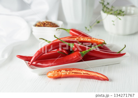 Fresh red chili peppers with on a white wooden table. 134271767