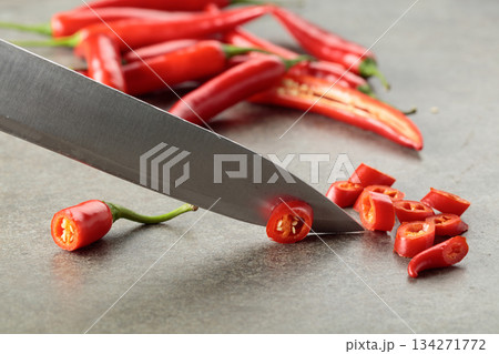 Kitchen knife and fresh red chili peppers. 134271772