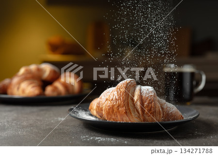 Croissants sprinkled with sugar powder. 134271788