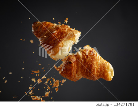 Croissant in air on a black background. 134271791