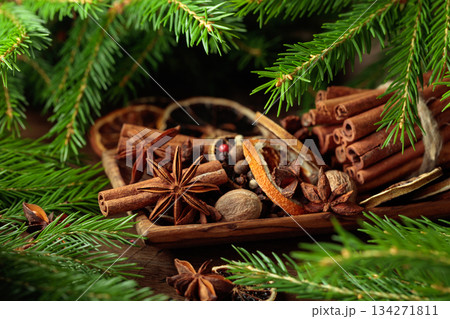 Spices and branches of Christmas tree on an old wooden table. 134271811