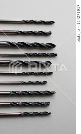 Set Of Variety Size Black Drills On White Surface. Stock Photo For Vertical Backgrounds Set Of Variety Size Black Drills On White Surface. Stock Photo For Vertical Backgrounds 134271917