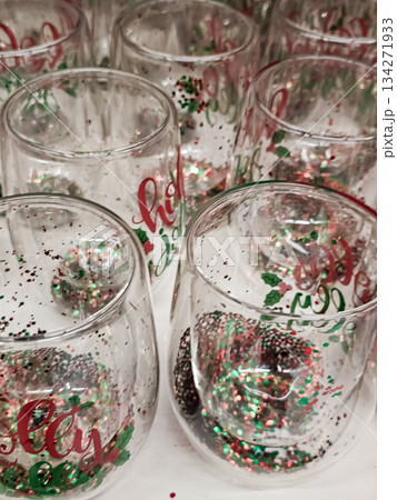 Festive Glass Christmas Cups with Glitter and Red Holiday Text 134271933