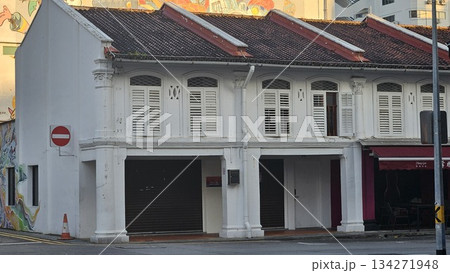 A colonial-style shophouse with shuttered windows  134271948