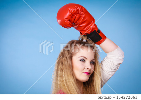 Cute girl in red gloves playing sports boxing 134272663