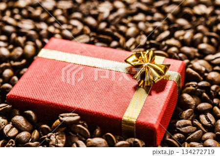 Red gift box on roasted coffee beans. 134272719