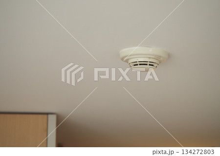 Smoke detector on ceiling in a room Smoke detector on ceiling in a room 134272803