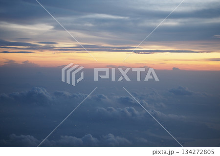 Sunset view above the clouds during a flight 134272805