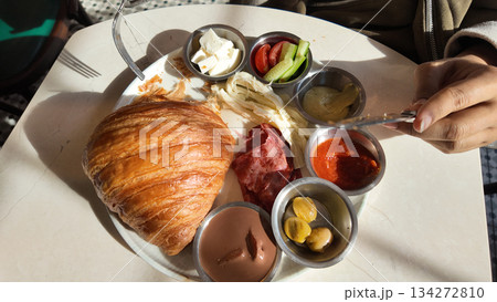 Eating breakfast in a cafe with a variety of food items 134272810