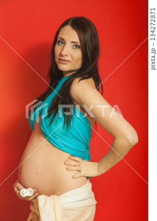 Adult woman showing her pregnant belly 134272871
