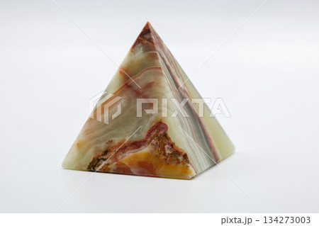 Polished stone pyramid abstract pattern closeup on white. 134273003