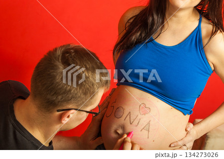Pregnant woman belly, father drawing on it 134273026