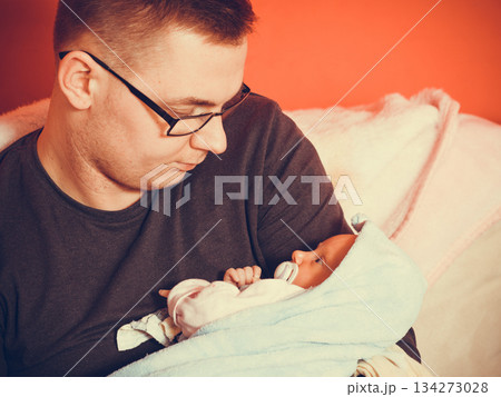 Father holding taking care of newborn baby 134273028