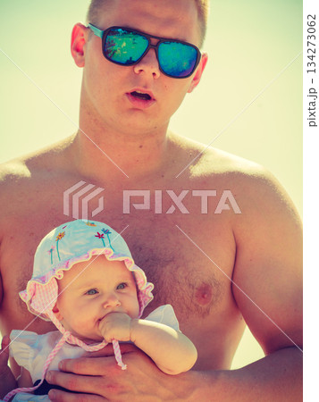 Man posing with baby on summer 134273062