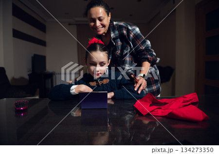 Mother And Daughter Get Ready For Christmas With Mirror Play At The Dinner Table Together 134273350