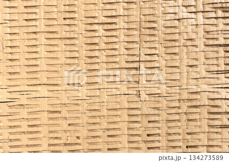 Shredded cardboard creates an abstract corrugated texture for sustainable packaging 134273589