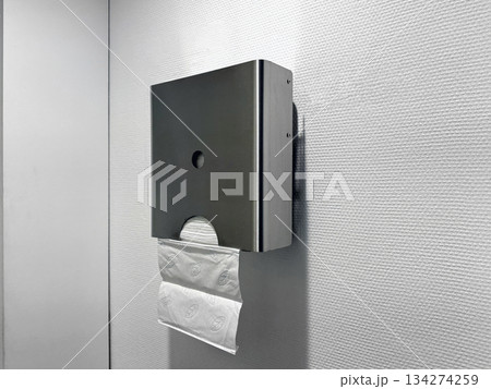 Hygienic paper towel dispenser for hand drying in bathroom. Hygienic paper towel dispenser for hand drying in bathroom. 134274259