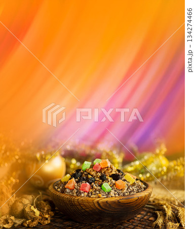Kutya began the celebration of Christmas in Ukraine. Kutia with poppy seeds and honey. Christmas porridge kutya over wooden background. Kutya began the celebration of Christmas in Ukraine. Kutia with poppy seeds and honey. Christmas porridge kutya over wooden background. 134274466