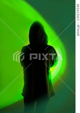 Ability to securely store data on a mobile device. Mystery man with mobile phone on vibrant neon light background. Ability to securely store data on a mobile device. Mystery man with mobile phone on vibrant neon light background. 134274546