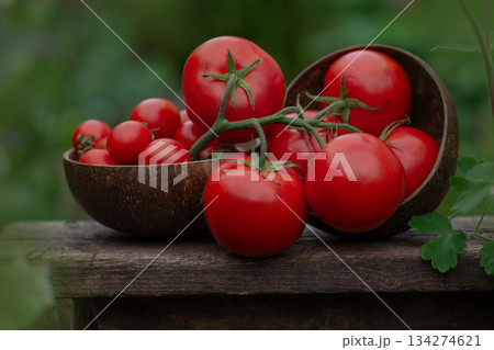 Red round tomatoes. Many red tomatoes on wooden table.Healthy organic red tomatoes on a wooden background. Red round tomatoes. Many red tomatoes on wooden table.Healthy organic red tomatoes on a wooden background. 134274621