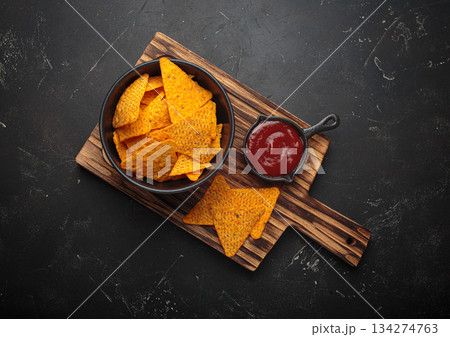Nachos tortilla chips salsa dip wooden board Mexican Tex-Mex snack fast food 134274763
