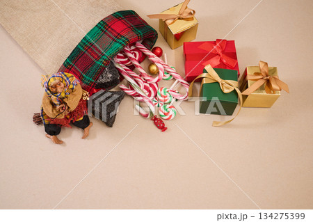 Epiphany Befana's stocking with sweet coal and candy. Italian Epiphany day. Epiphany Befana's stocking with sweet coal and candy. Italian Epiphany day. 134275399